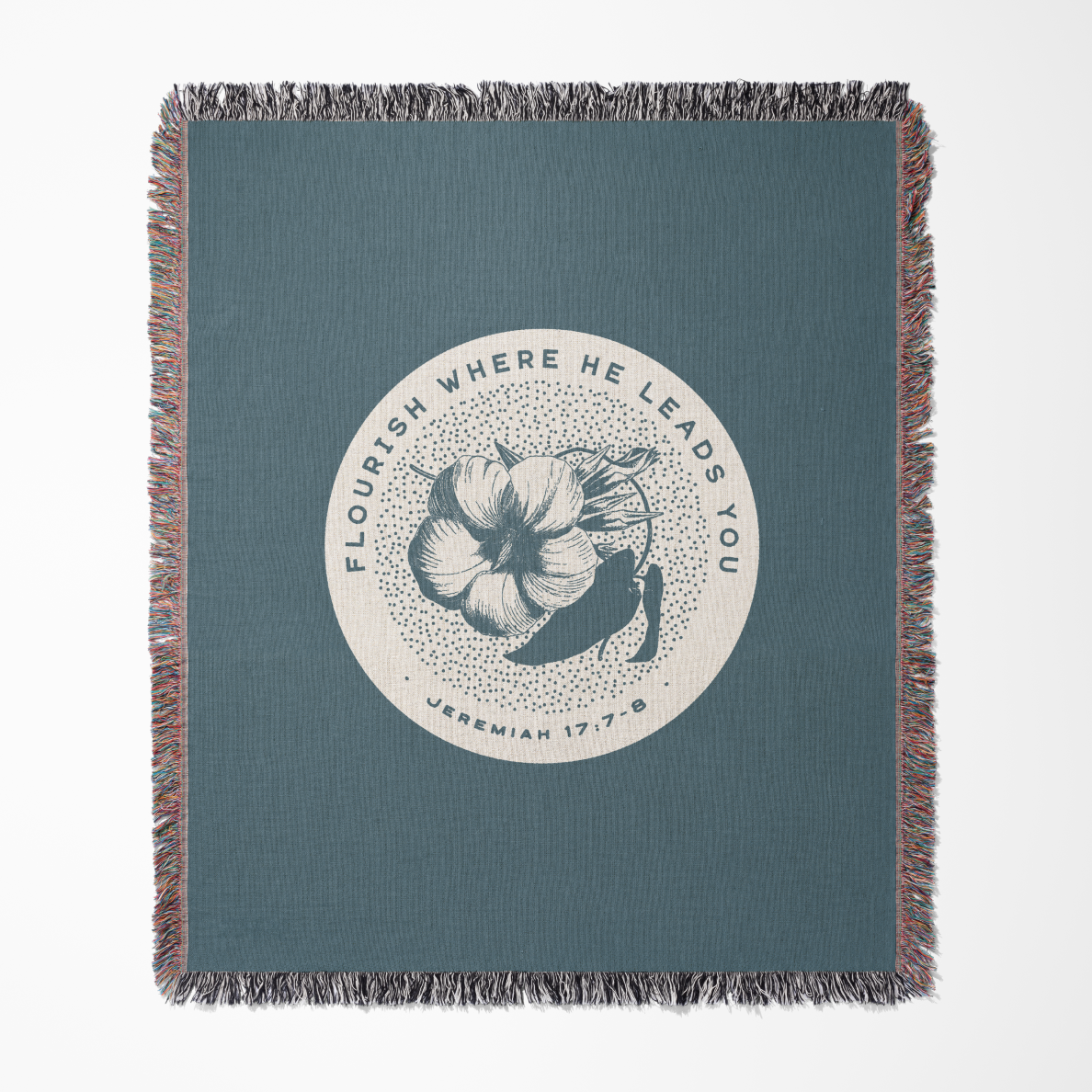 Blue throw blanket with floral design and text on a white background