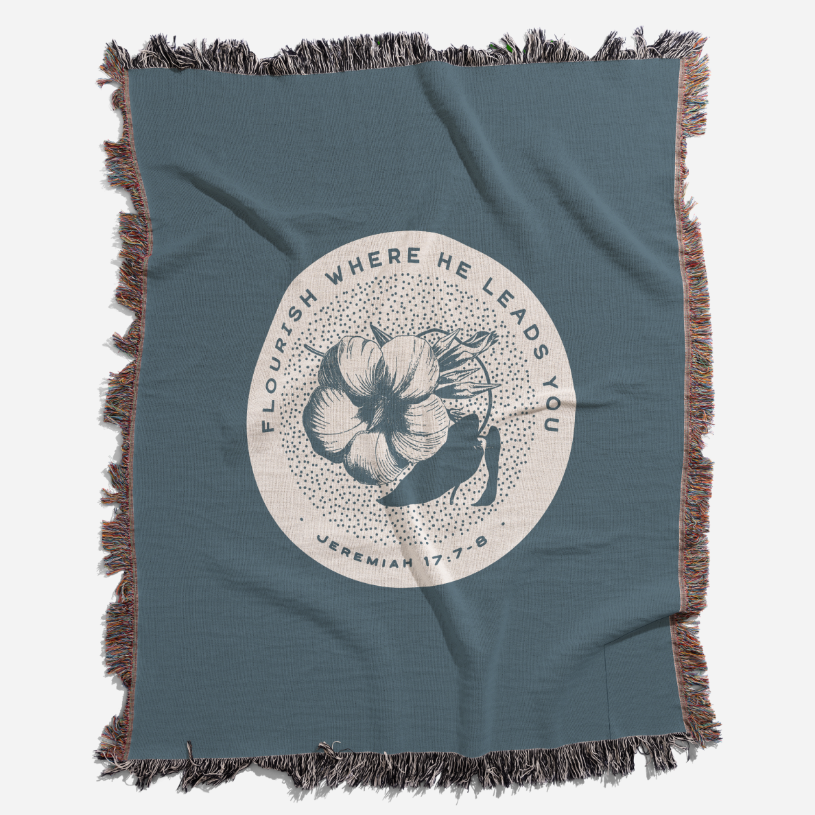 Blue throw blanket with floral design and text on a white background