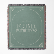 Green woven blanket with 'Found in Faithfulness' text on a white background