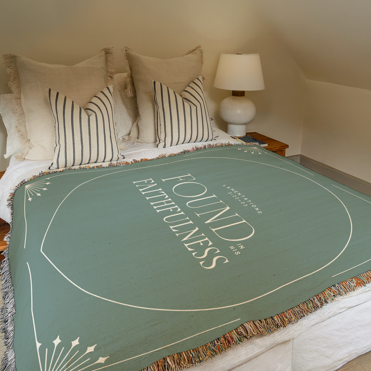 Green blanket with 'Found Fullness' text on a bed in a bedroom setting.