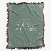 Green blanket with 'Found in His Faithfulness' text on a white background