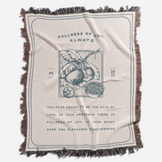 Blanket with text and fruit design on a white background