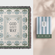 Decorative blanket with 'God always makes a way' text and matching notebook on a neutral background