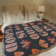 God is Good blanket on bed.
