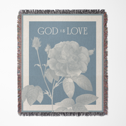 Blanket with floral design and 'God is Love' text on a blue background