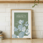 Framed artwork with floral design and text on a tiled wall