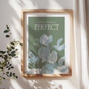 Framed artwork with floral design and motivational quote on a light background