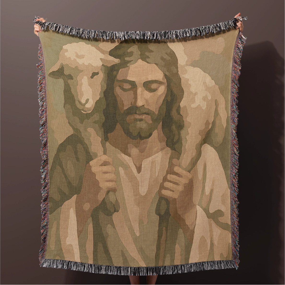Woven blanket showing Jesus carrying a sheep, made from 100% cotton with fringe edges; a comforting Christian gift or faith-based decor for home or nursery.