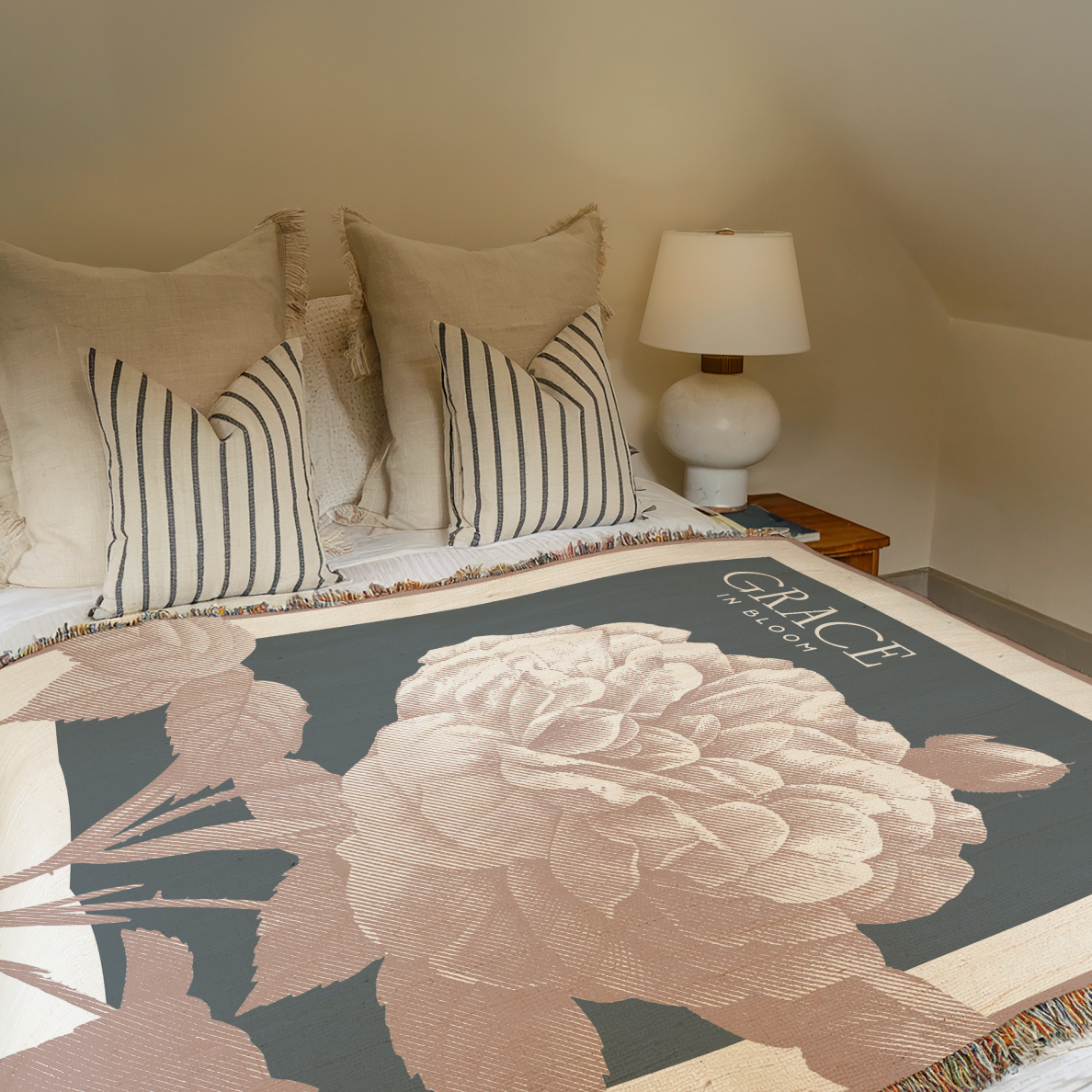 Bed with floral blanket and striped pillows in a bedroom setting.
