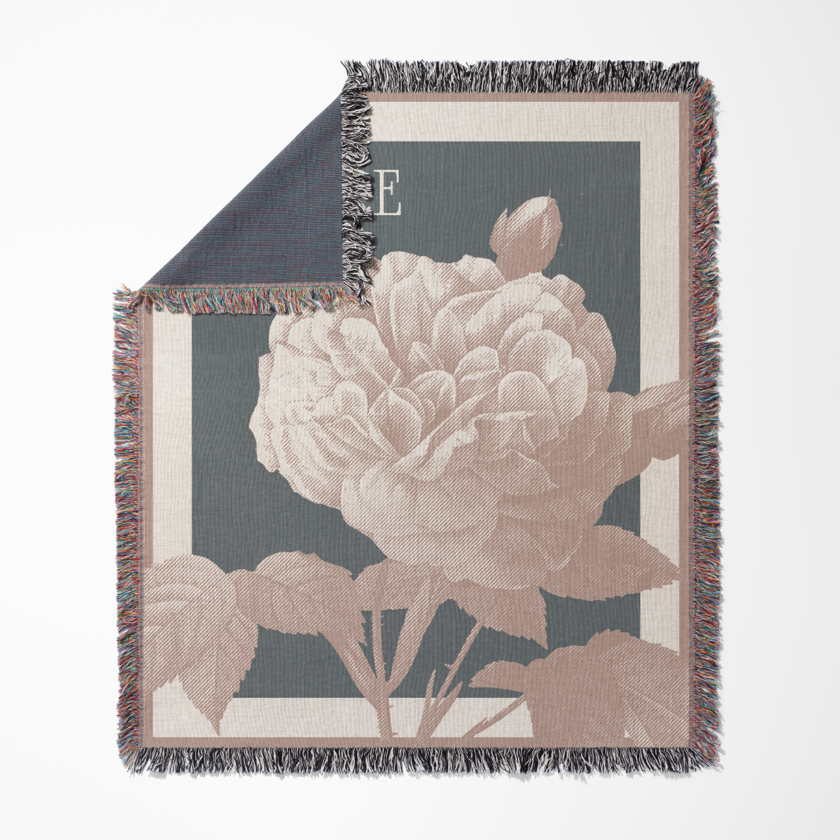 Floral patterned throw blanket with a large pink flower on a dark background