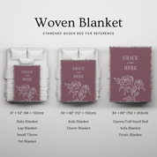 Woven blanket with 'Grace Lives Here' text and floral design, shown in various sizes on a bed.