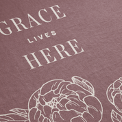 Text 'GRACE LIVES HERE' with floral design on a textured purple background