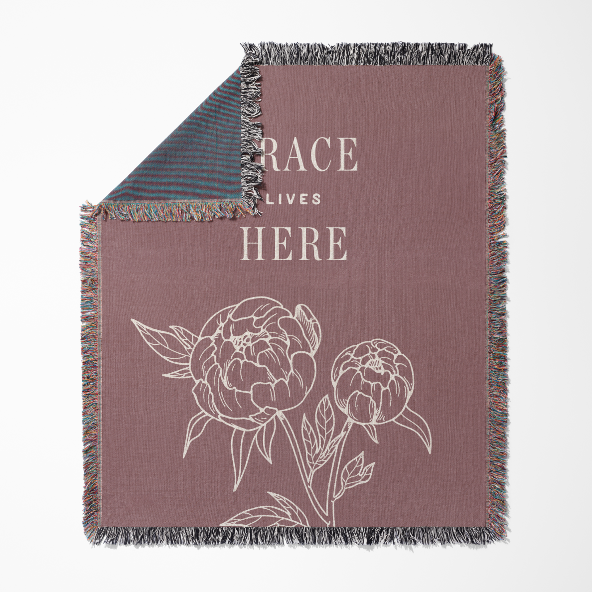 Blanket with floral design and text 'RACE LIVES HERE' on a white background