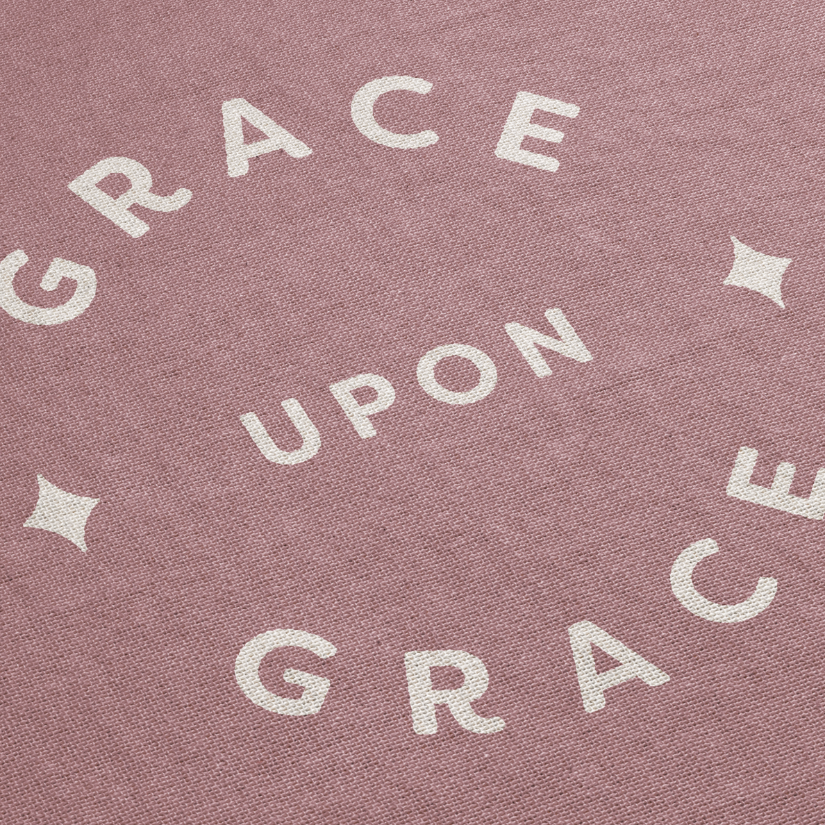 Text pattern with 'GRACE UPON GRACE' on a pink background