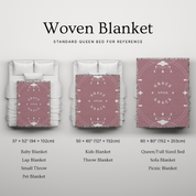 Woven blanket with size chart on a light gray background