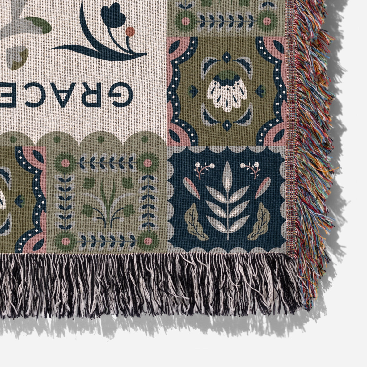 Faith-inspired woven blanket featuring the phrase “Grace Upon Grace” with colorful fringed edges, perfect for Christian home decor and gifts.