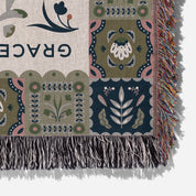 Faith-inspired woven blanket featuring the phrase “Grace Upon Grace” with colorful fringed edges, perfect for Christian home decor and gifts.