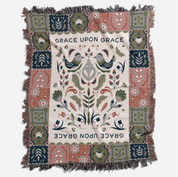 Faith-inspired woven blanket featuring the phrase “Grace Upon Grace” with colorful fringed edges, perfect for Christian home decor and gifts.