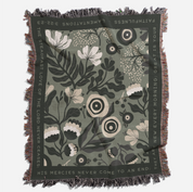 Floral patterned throw blanket with text on a white background