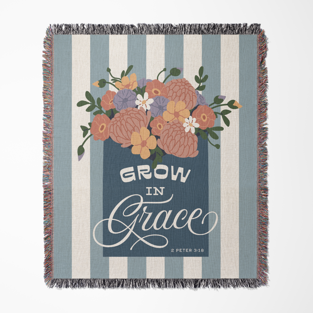 Blanket with floral design and 'Grow in Grace' text on a striped background