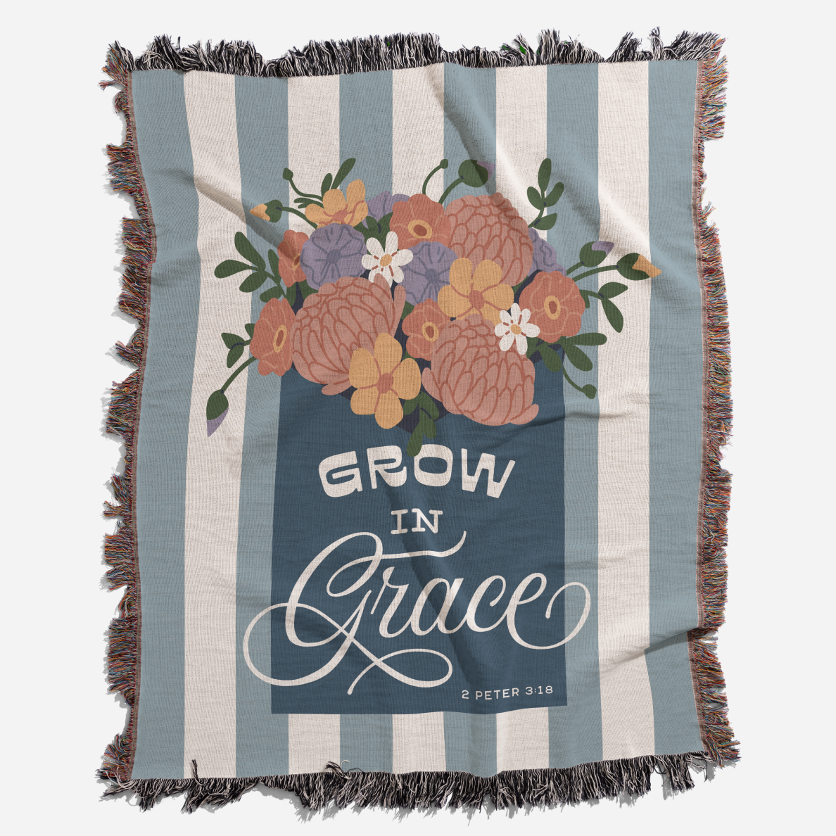 Blanket with floral design and 'Grow in Grace' text on a striped background
