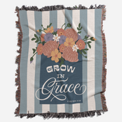 Blanket with floral design and 'Grow in Grace' text on a striped background