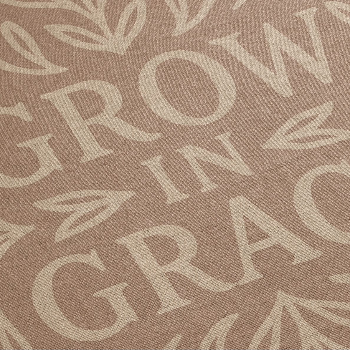 Neutral-toned woven blanket with the phrase "Grow in Grace" surrounded by elegant floral design; made from 100% cotton with fringe, perfect Christian gift or decor.