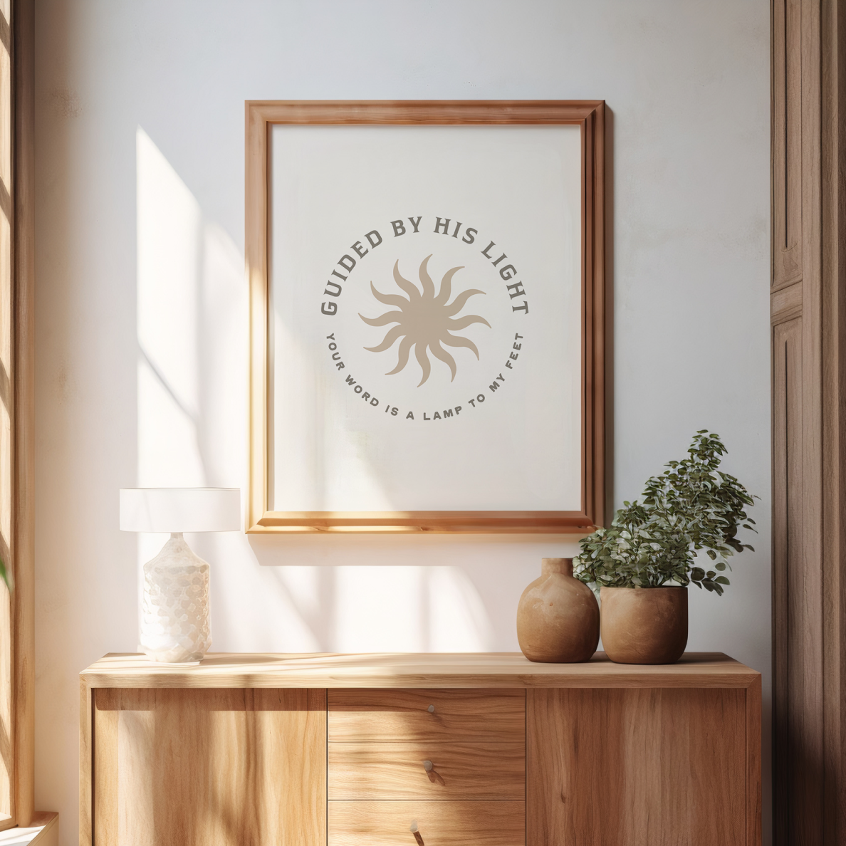 Framed artwork with motivational quote on a wall above a wooden console table.