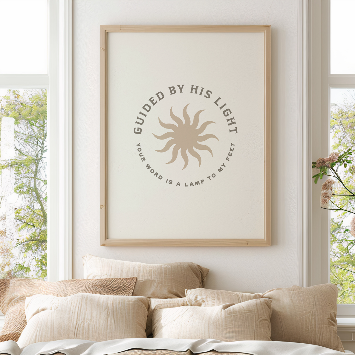 Framed artwork with motivational quote on a wall above a bed with pillows.