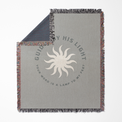 Gray blanket with sun design and text on a white background