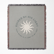 Gray blanket with sun design and text on a white background