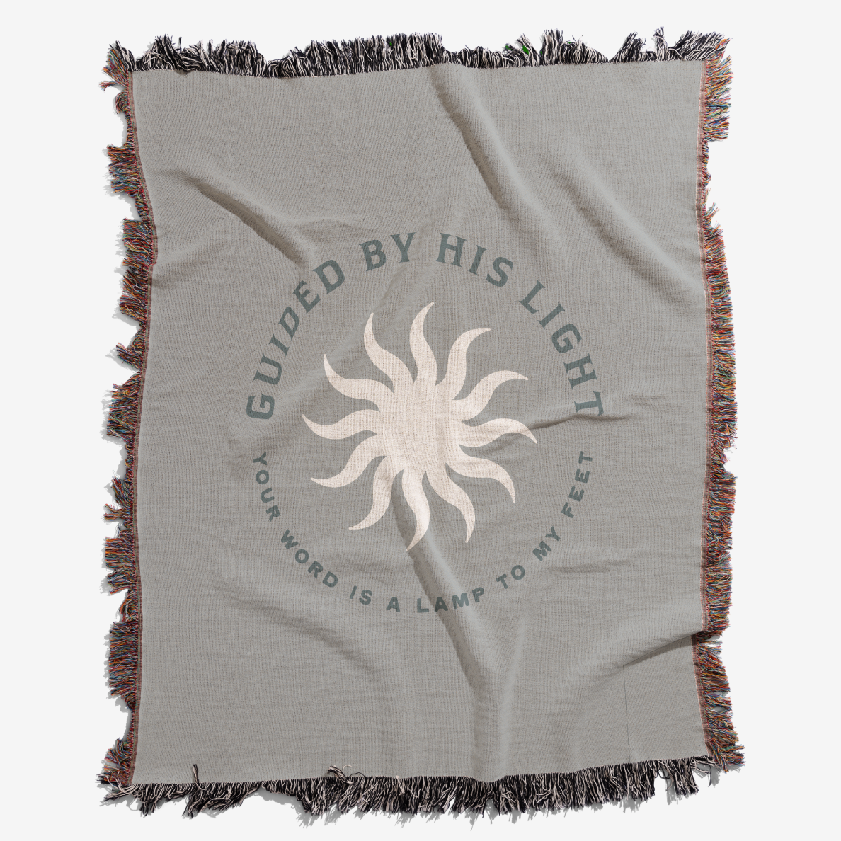 Gray blanket with sun design and text 'Guided by His Light' on a white background