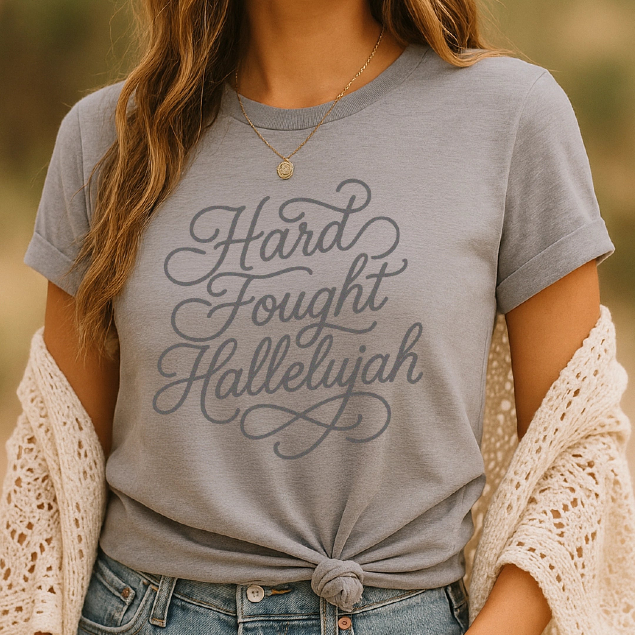 Unisex Christian t-shirt with hand-lettered “Hard Fought Hallelujah” text; soft cotton faith-based shirt for worship, encouragement, and praise through trials.