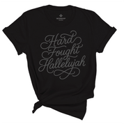 Unisex Christian t-shirt with hand-lettered “Hard Fought Hallelujah” text; soft cotton faith-based shirt for worship, encouragement, and praise through trials.