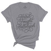 Unisex Christian t-shirt with hand-lettered “Hard Fought Hallelujah” text; soft cotton faith-based shirt for worship, encouragement, and praise through trials.