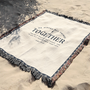 Blanket with 'He holds all things together' text on a sandy background