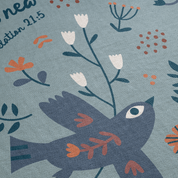 Details on blanket - bird and text.
