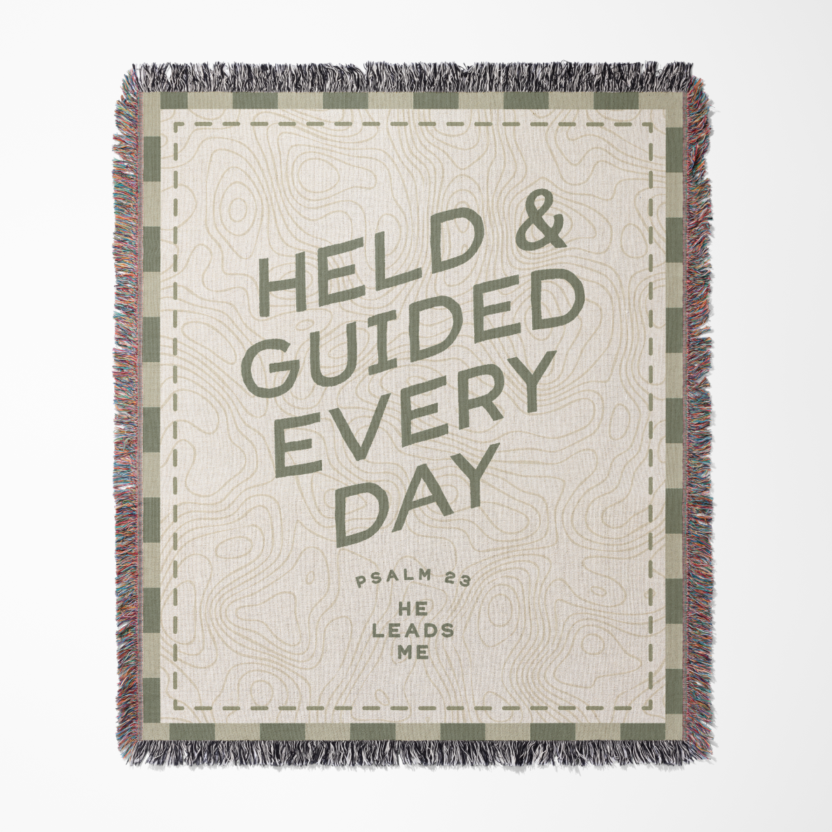Blanket with text 'HELD & GUIDED EVERY DAY' and decorative border on a white background