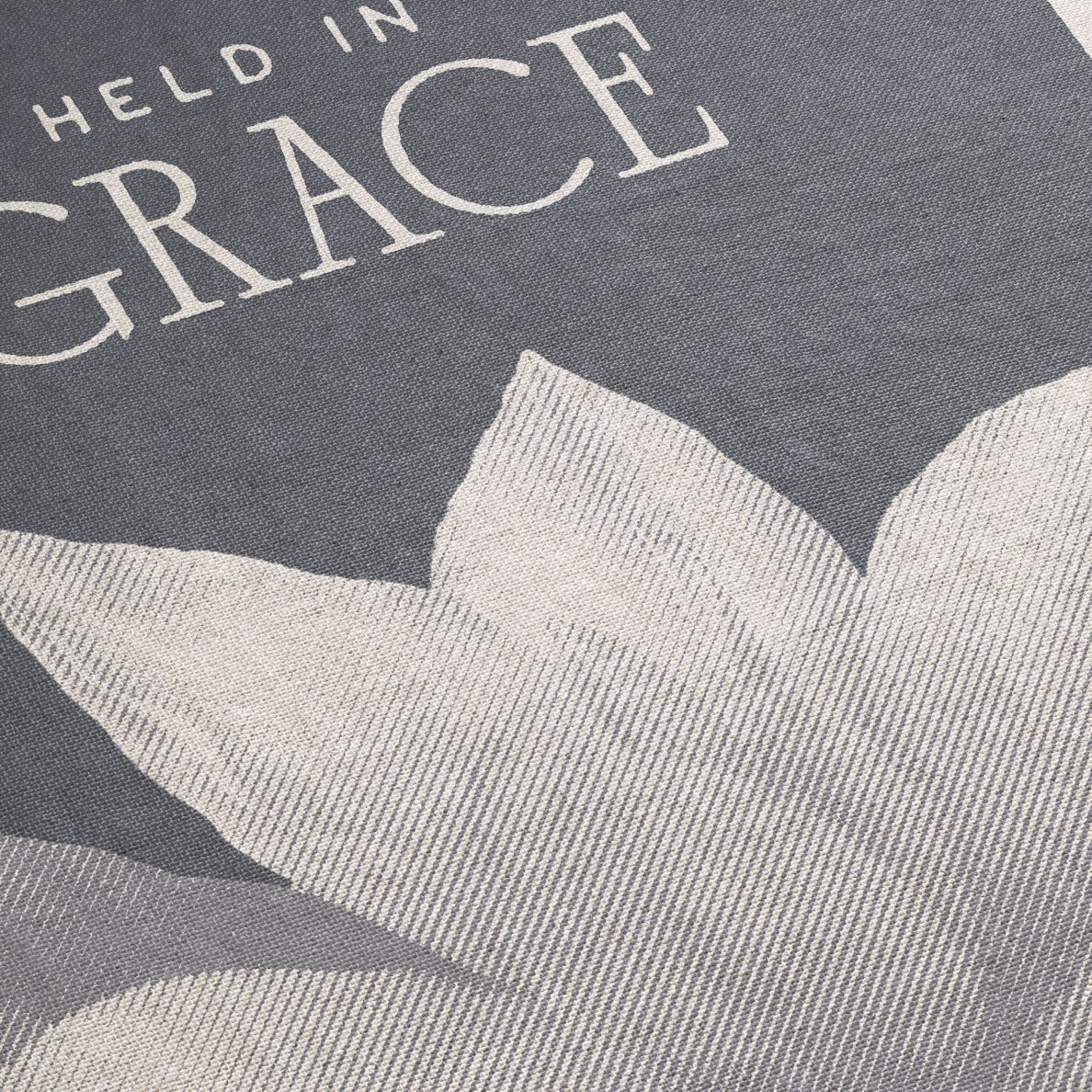 Text 'HELD IN GRACE' on a textured gray background