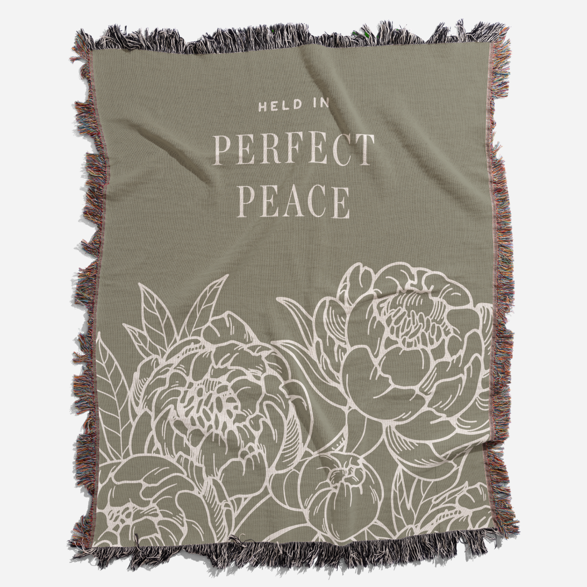 Olive green blanket with floral design and 'Held in Perfect Peace' text on a white background