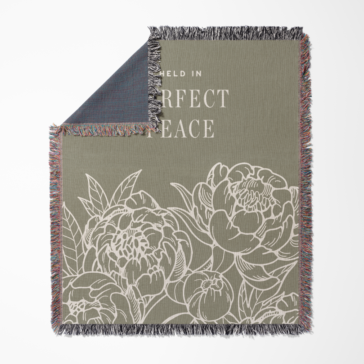 Floral patterned blanket with text 'Held in Perfect Peace' on a white background