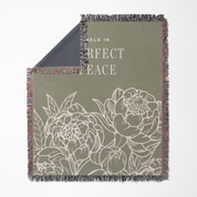 Floral patterned blanket with text 'Held in Perfect Peace' on a white background