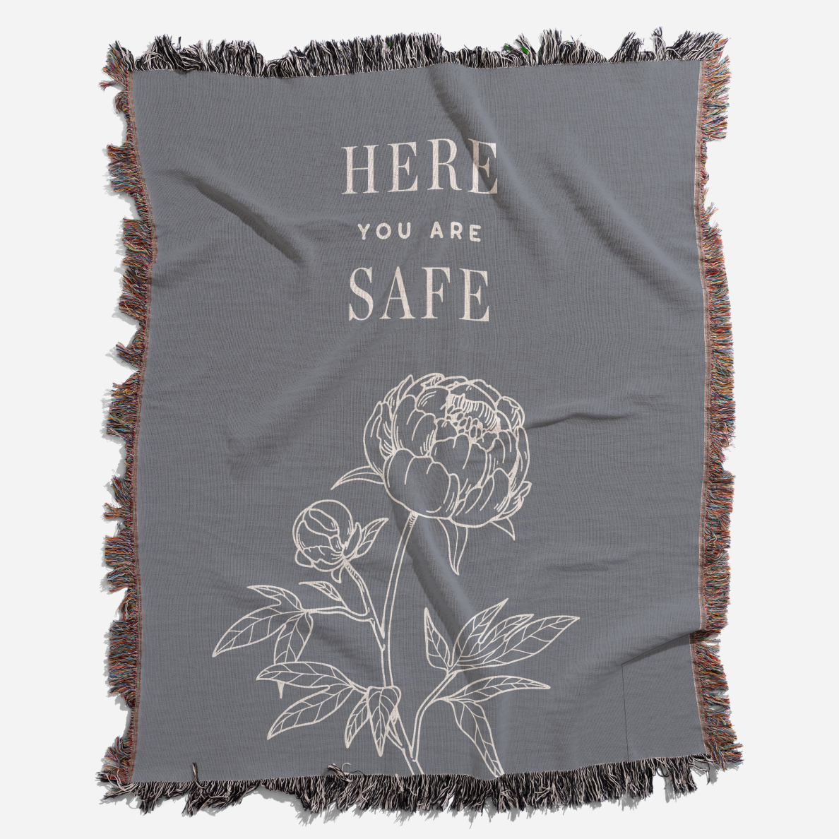 Gray blanket with floral design and 'Here You Are Safe' text on a white background