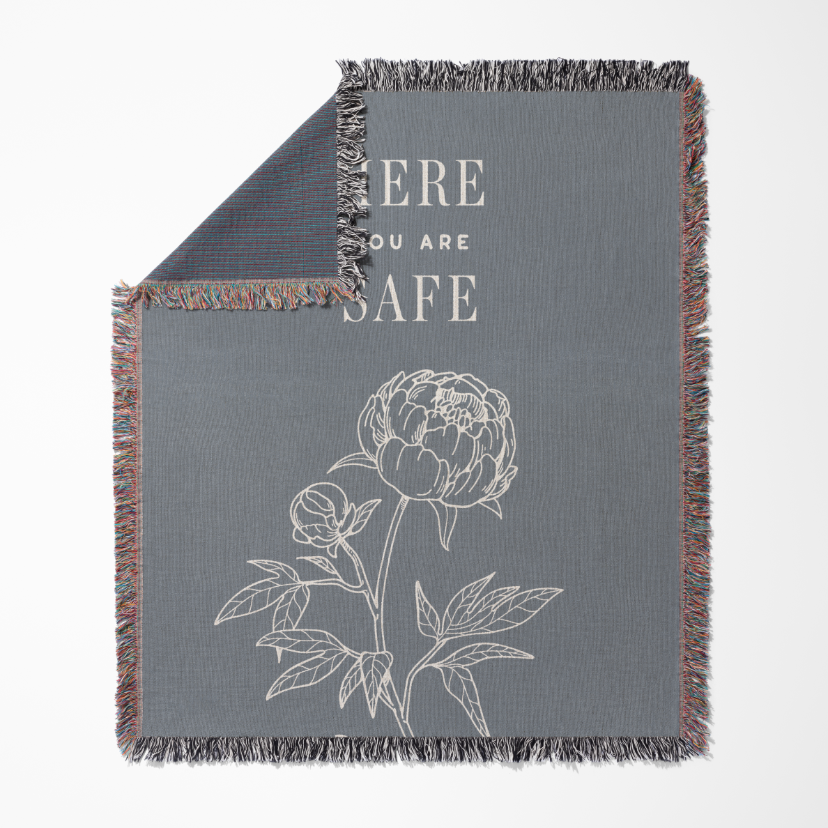 Gray blanket with floral design and 'Here You Are Safe' text on a white background