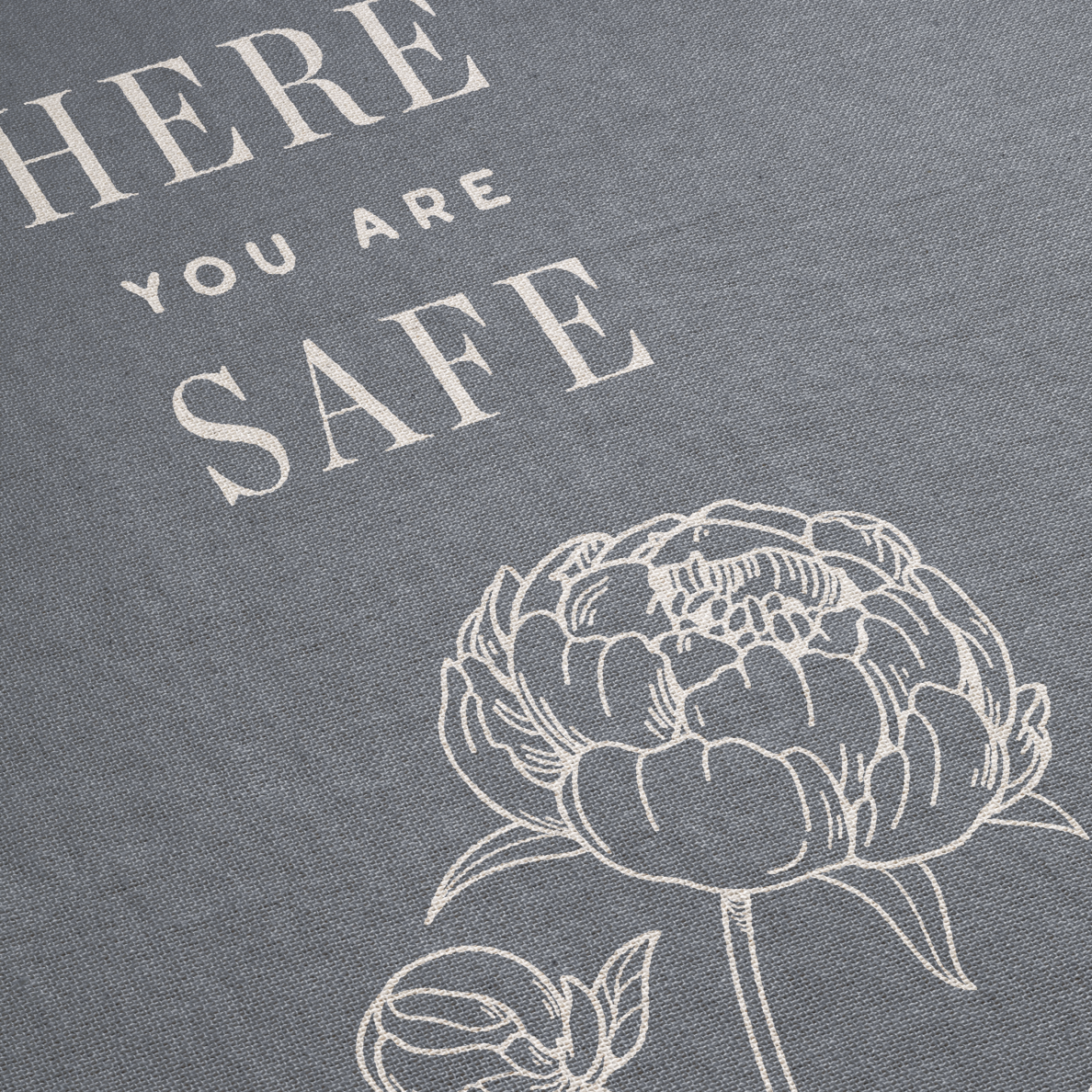 Floral design with 'Here you are safe' text on a gray background