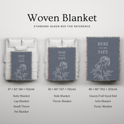 Woven blanket with floral design and text on a bed, showing different sizes.