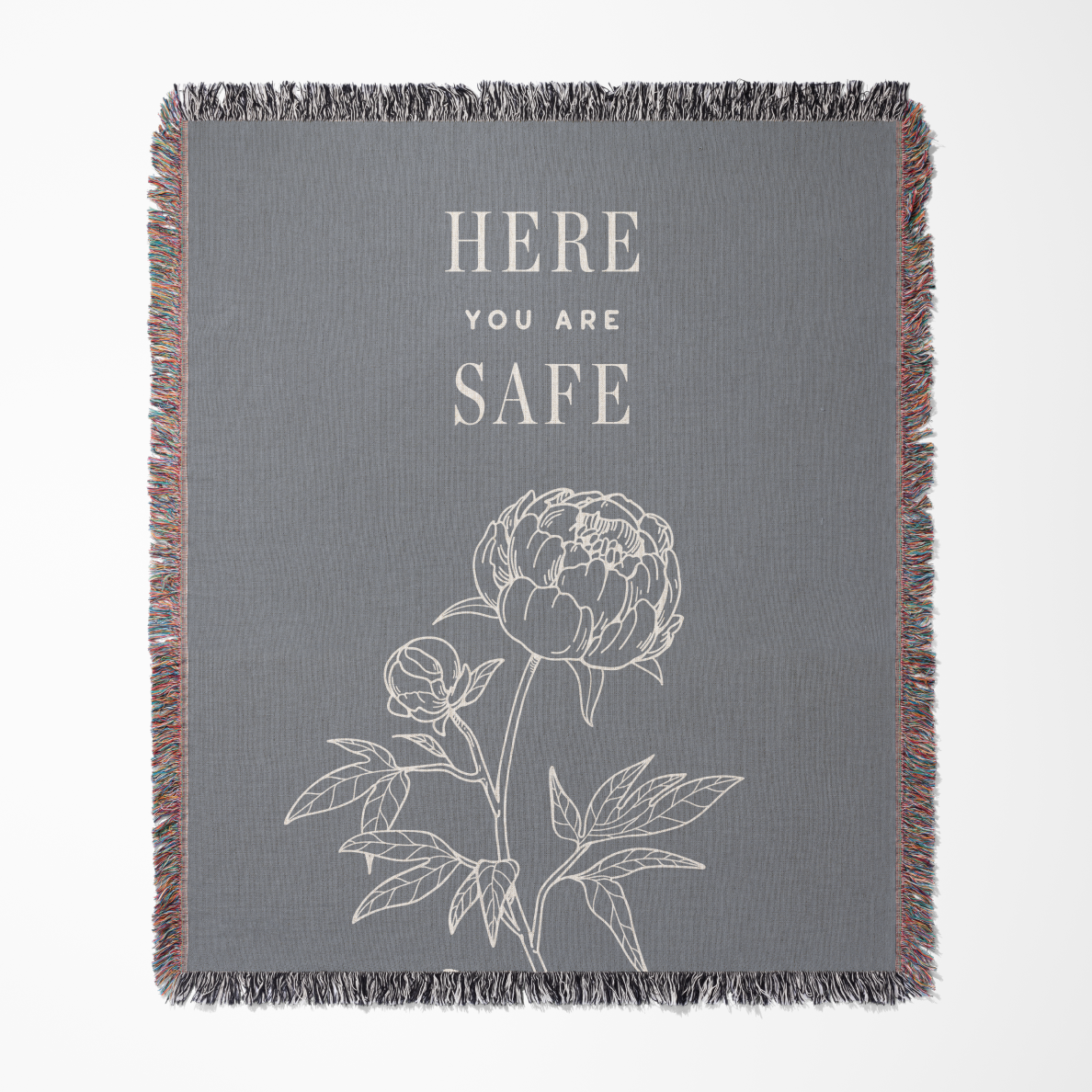 Gray blanket with floral design and 'Here You Are Safe' text on a white background