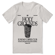 Christian t-shirt with “Holy Grounds Sunday Morning Coffee Club” in retro script; unisex cotton tee for faith, fellowship, and coffee-loving believers.