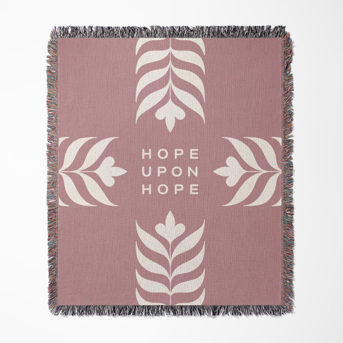 Pink blanket with white leaf patterns and 'Hope Upon Hope' text on a white background