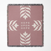 Pink blanket with white leaf patterns and 'Hope Upon Hope' text on a white background